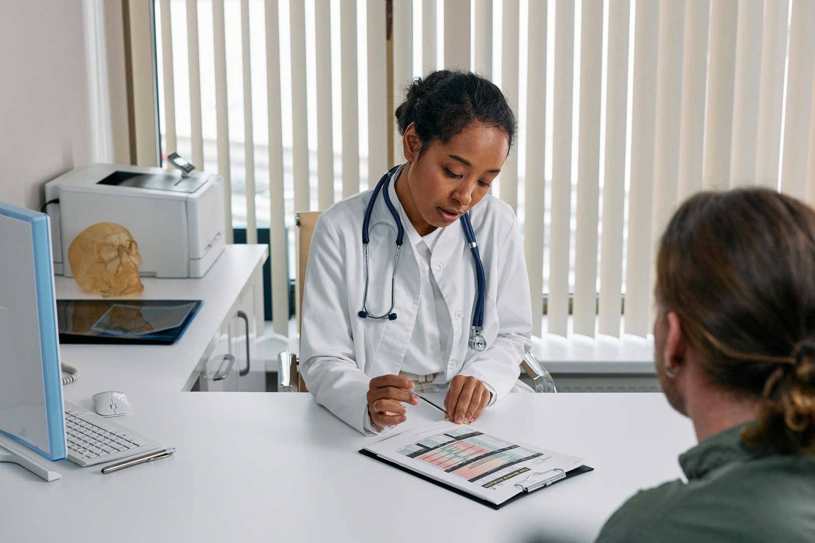 Clinical medical assistant engaging in professional patient communication in a healthcare setting